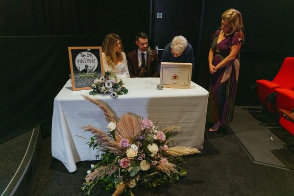 Bride and groom at table flowers photo frames