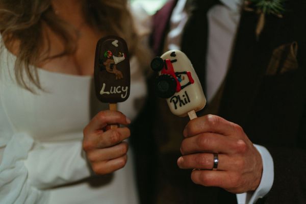 Bride and groom enjoying the chocolate lollipops