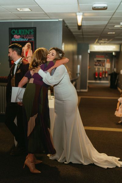 Groom and friend embrace and hug