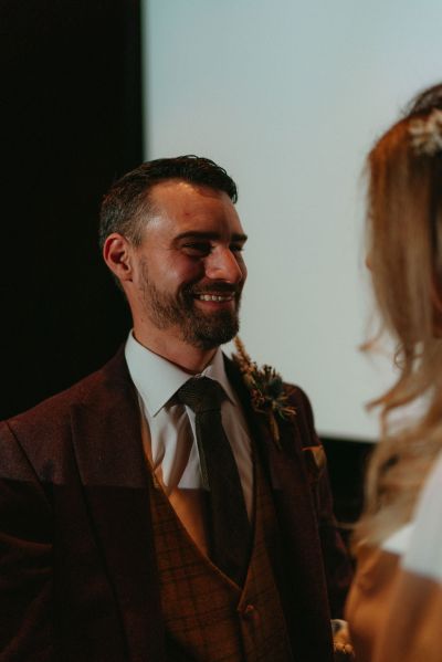 Groom looking at bride inside cinema