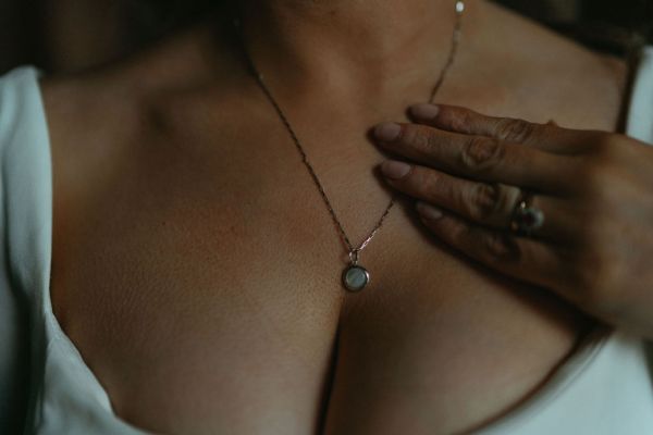 Breast bust detail necklace brides hand on chest