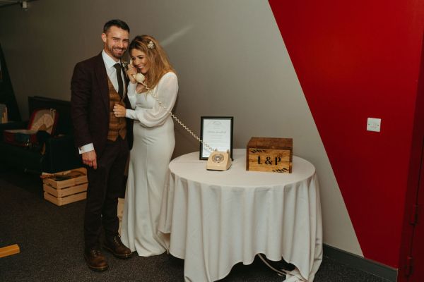 Bride and groom pose at table