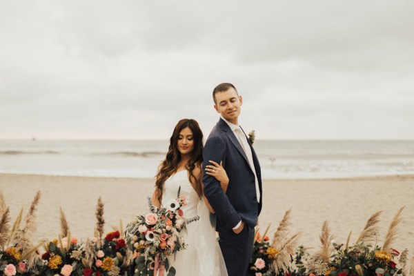 Bride and groom in front of sea ocean sandy landscape location