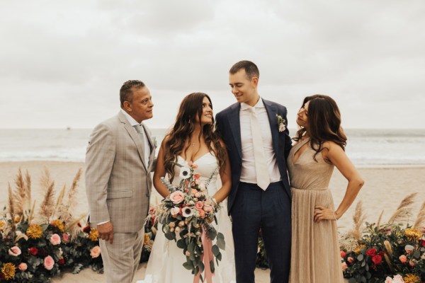 Bride groom and parents mother father beach setting