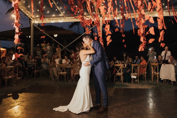 Bride and groom dance together on dancefloor