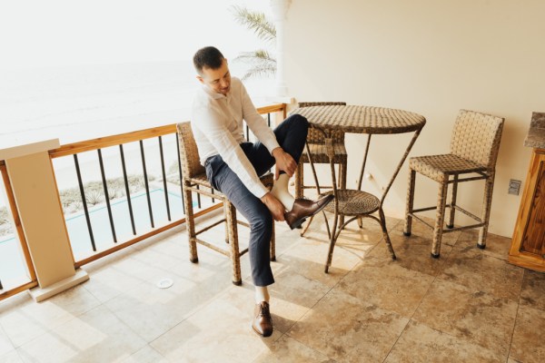 Groom puts on his brogues shoes