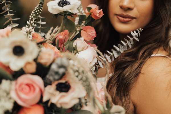 Close up of brides face lips and bouquet flowers