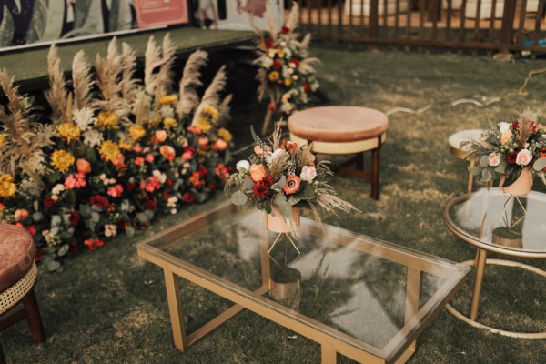 Flowers in vase resting on glass table and chair