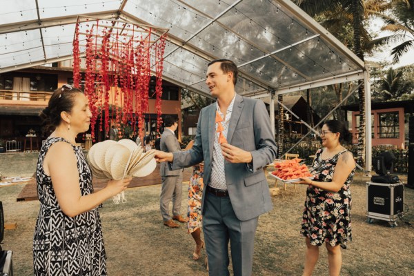 Guest being handed a fan to cool down