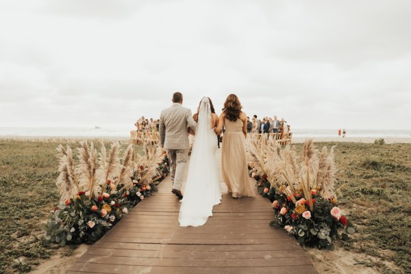 Bride mother and father walking down the aisle from behind