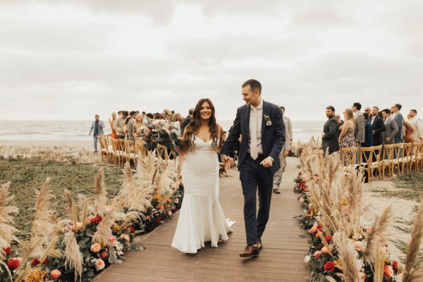 Bride and groom exit ceremony hand in hand