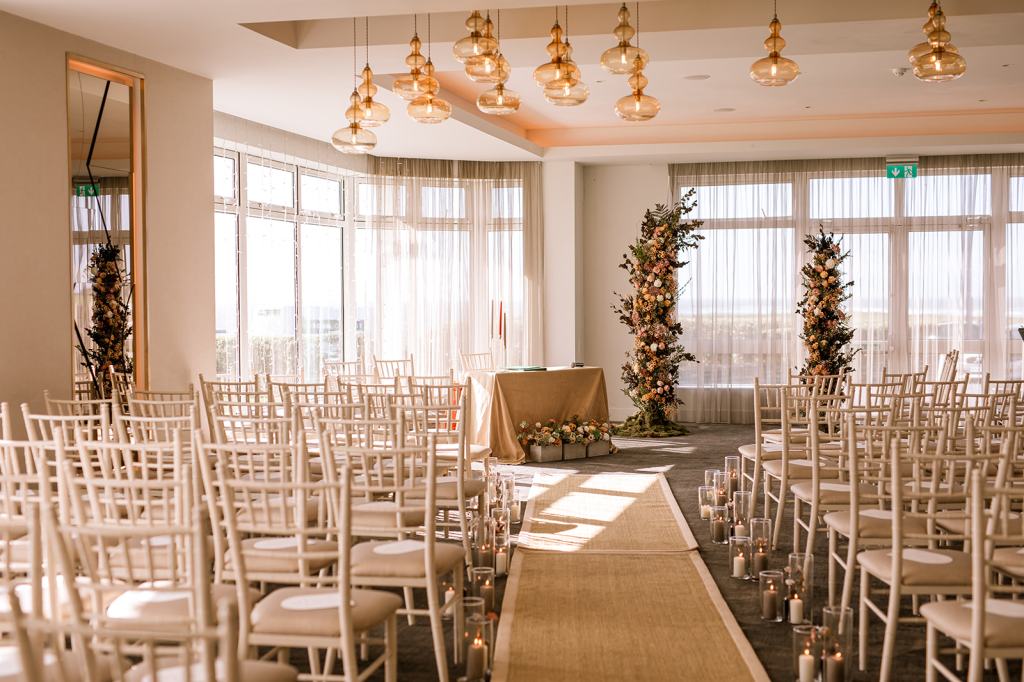 Ceremony setting aisle gold carpet and chairs alter in view