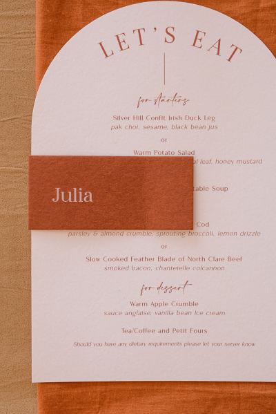 Autumnal branch from tree and dinner menu and cutlery Julia name