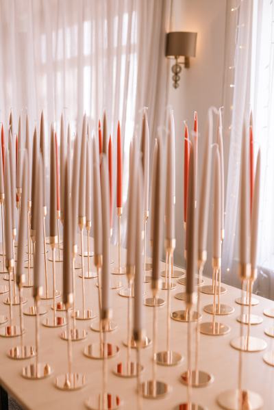 Different coloured autumnal candles laid out on table