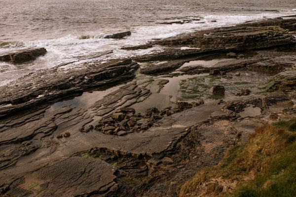 Rocky beach setting with sea ocean waves in background