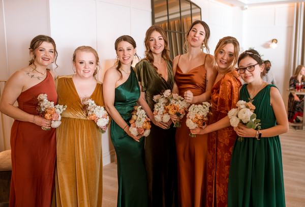 Bridesmaids in a row holding their bouquets