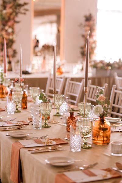 Empty dining room setting lights table and chairs candles lit for guests