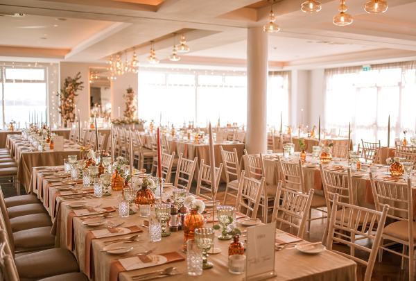 Empty dining room setting lights table and chairs candles lit for guests