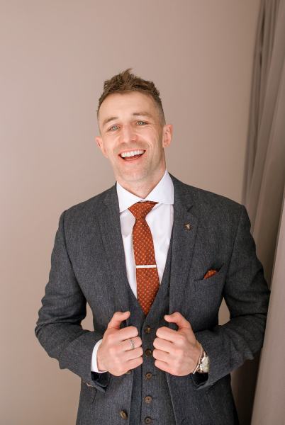 Groom is ready smiling suit and red tie