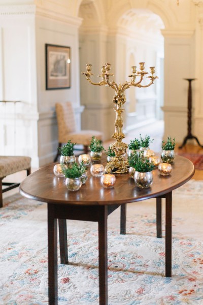 Wooden table with flowers and candles on top