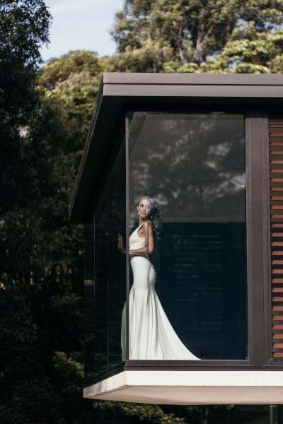 Grace Loves Lace: Jones Dress model stands at window to house white bridal gown