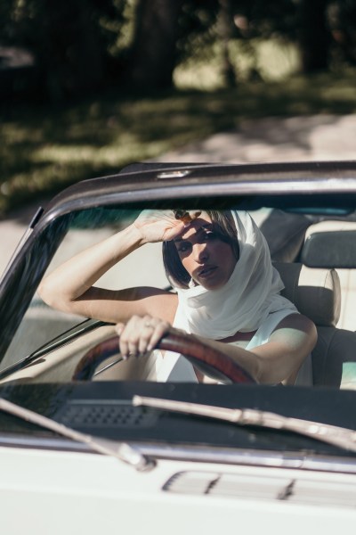 Grace Loves Lace: Jones Dress model sits in car shawl around neck bride