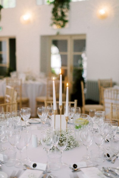 Empty table setting dining room candles lit cutlery