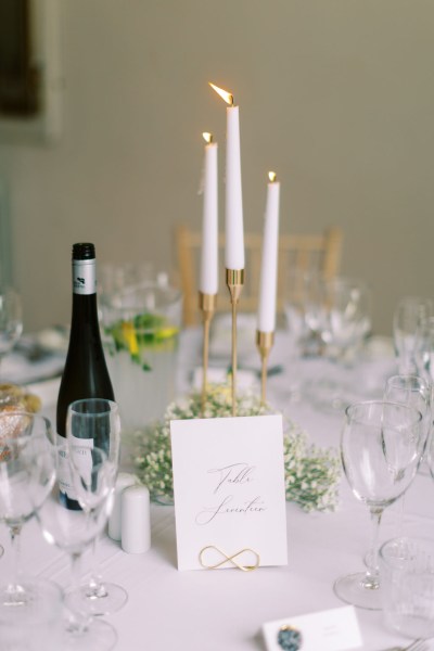 Wine bottle on table and candles lit