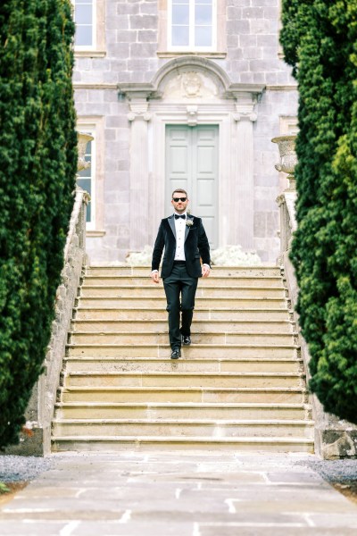 Groom wearing shades/sunglasses walk down the steps