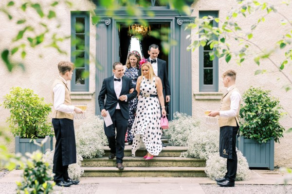 Polka dot woman and man walk down the steps