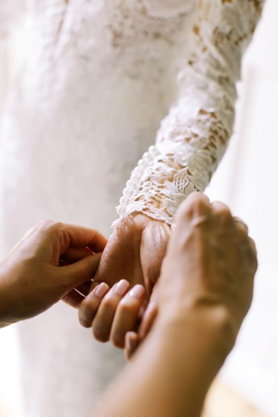 Bride holds out hand jewelry bracelet getting ready