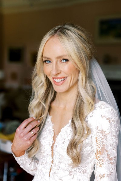 Bride smiles wearing veil ready