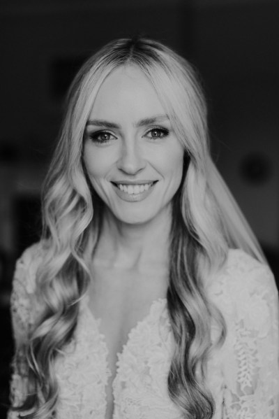 Close up of blonde bride smiling black and white