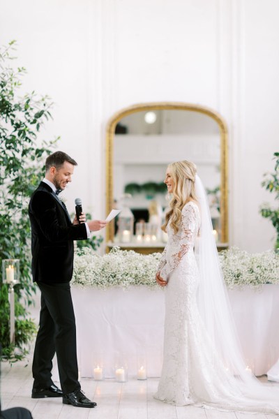 Groom reads out his vows to bride into microphone