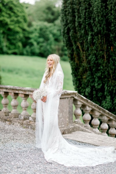 Bride on her own standing at steps stairs