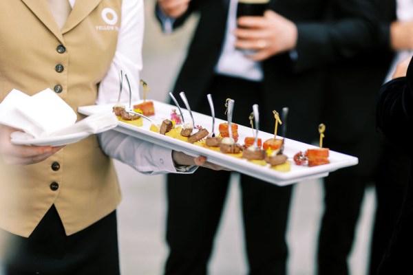 Waiter serving food canapes finger food