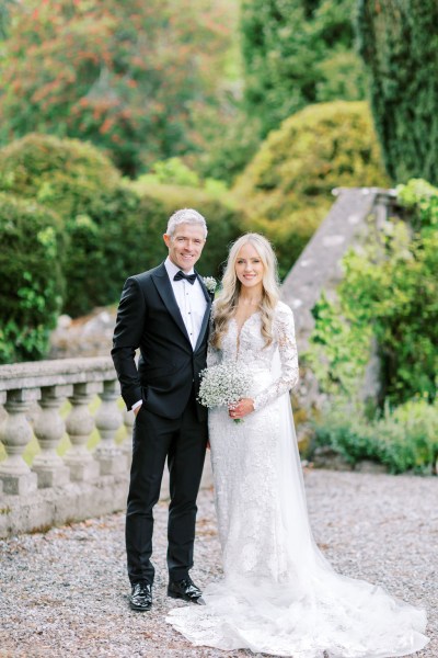 Father of the bride poses in garden