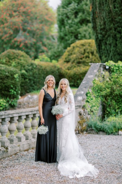 Bride and bridesmaid poses in garden