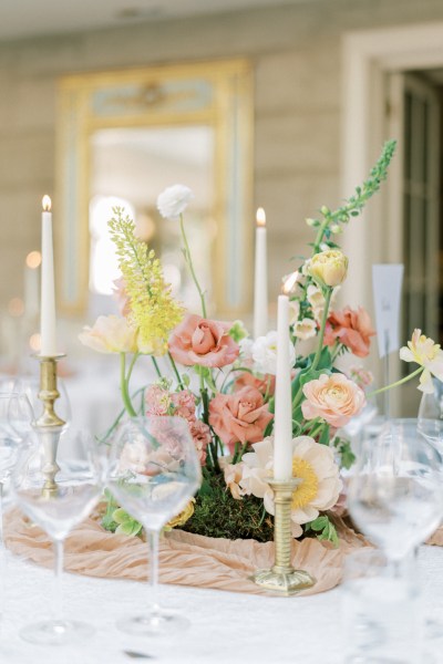 Roses cutlery on table candles lit flowers on white tablecloth