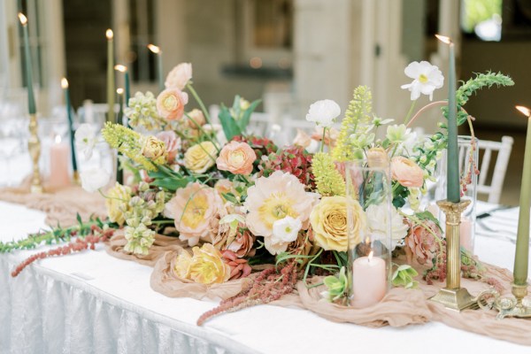 Roses cutlery on table candles lit flowers on white tablecloth