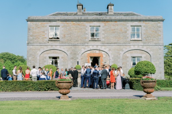 Exterior wedding venue blue sky atmosphere shot of guests