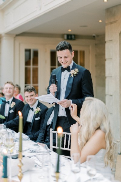 Groom reading speech to bride