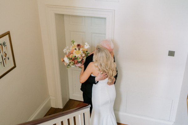 Father of the bride hugs her in emotional moment