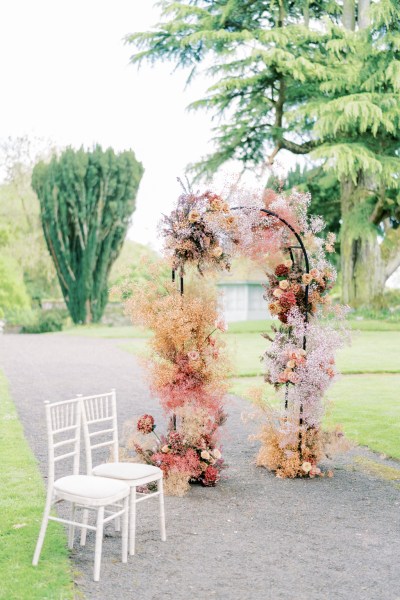 Alter setting and two white chairs ceremony for bride and groom