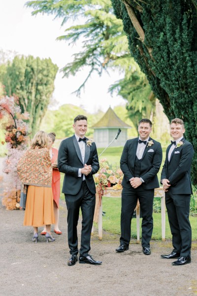 Groom and groomsmen await the bride and bridesmaids