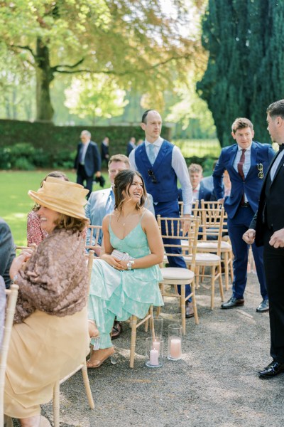 Guests awaiting the bride seated in seats during ceremony