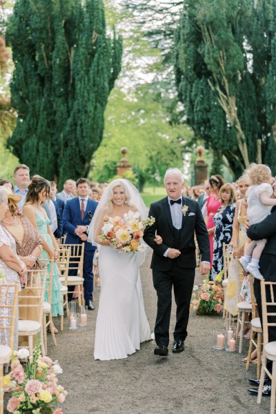 Father of the bride walks her down the aisle