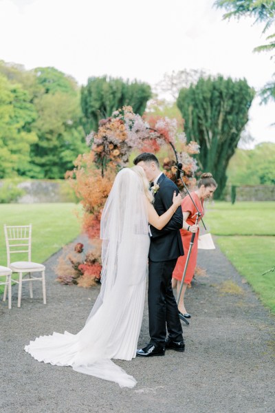 Bride and groom kiss at the alter