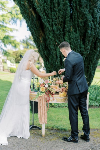 Bride and groom light candles at the alter table