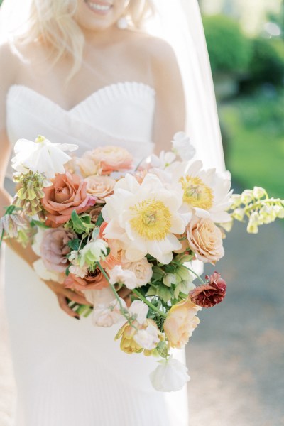 Bouquet in focus bride holds flowers